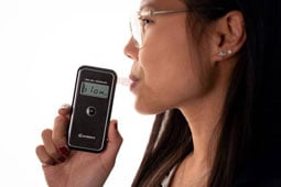 Person blowing into the AlcoSense Stealth